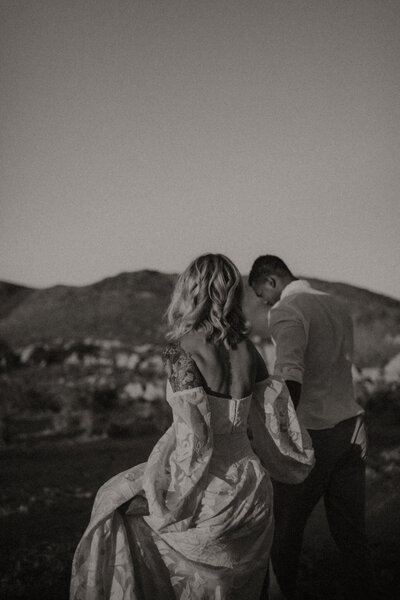 A husband and wife walking hand in hand, away from the camera, during their Joshua Tree National Park elopement.