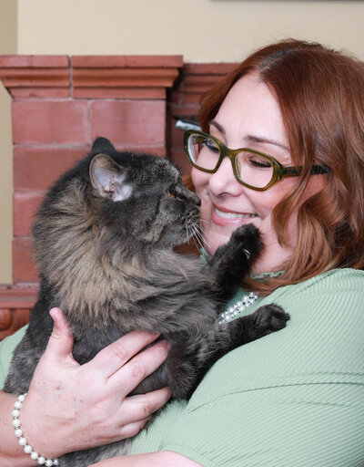 Kim holding her cat in her lap