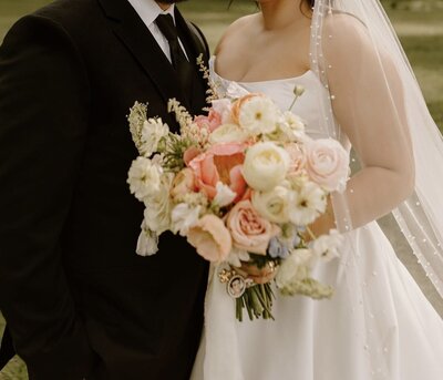 closeup of bridal bouquet with green and white flowers