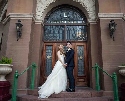 Bride and Groom poses outside of The Driskell Hotel in Austin, Texas