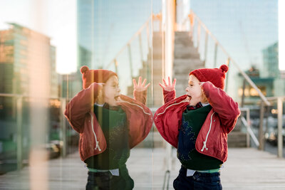 boy looking at his reflection during ICA family photography session