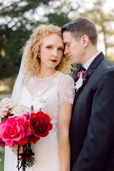 Editorial-style sunset portrait of bride and groom standing together after their intimate backyard wedding in Richmond, Virginia.