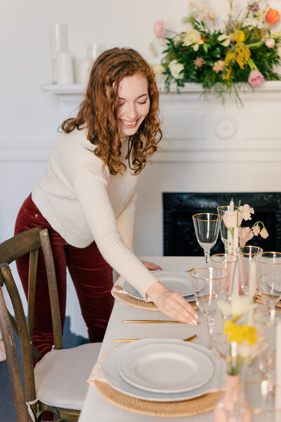 Wedding planner adjusting a table setting