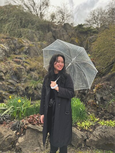 A smiling girl with an umbrella