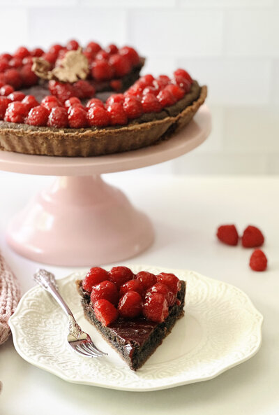 a chocolate tart topped with candied raspberries