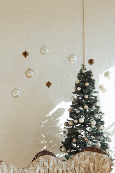 Christmas display with dangling ornaments and a tree at The Archer Atelier