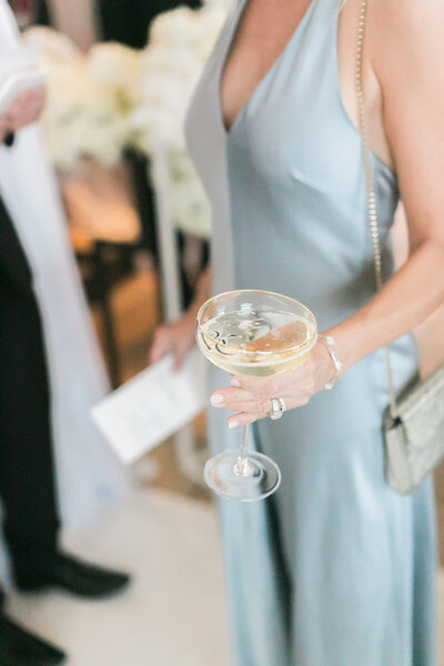 Woman holds cocktail at a wedding reception