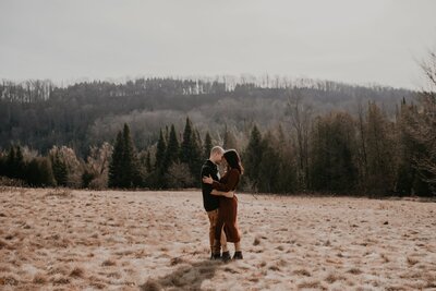 Bride and groom pose for a wedding day photo at the Century Barn, just outside of London, ON. The bride and groom are standing chest-to-chest. The groom's head is resting gently against the bride's temple with his eyes closed. The bride's face is side-profile to the camera with her eyes gently and dreamily closed. Captured by top London, ON wedding photographer Ashlee Ellison