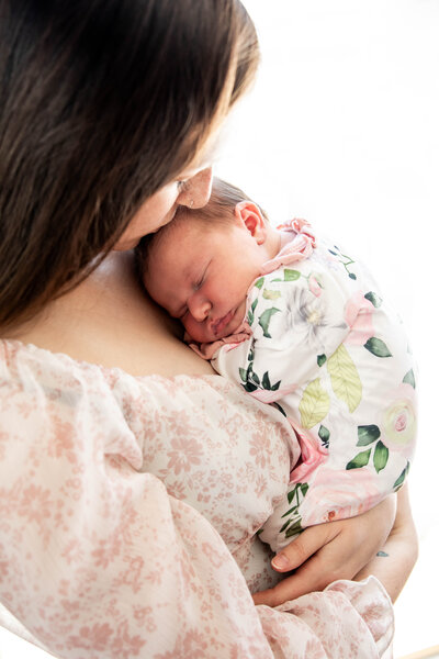 Photo of Mom holding baby to chest | Taken By Maine Newborn Photographer