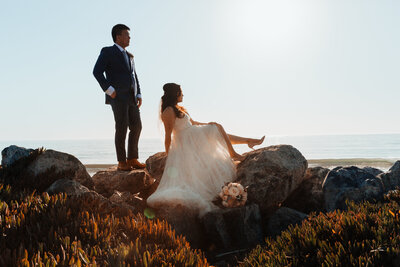 Bride and Groom on rocks by ocean