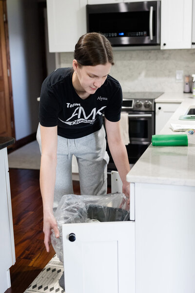 Professional cleaner changing garbage