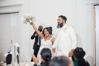 Exciting bouquet toss moment at a stylish wedding reception, planned by a luxury wedding coordinator.