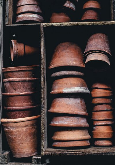 A stack of clay garden pots in different sizes.