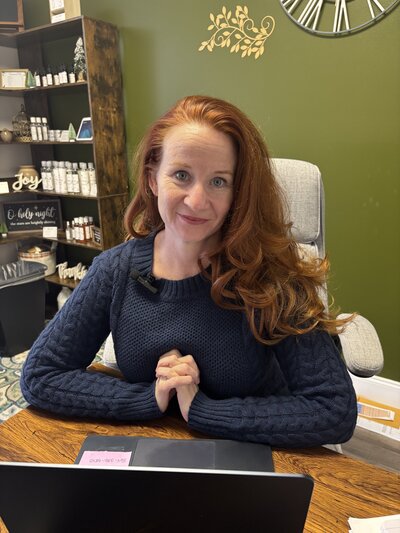 Jenny smiling at her desk, ready to teach
