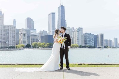 Bride and groom kiss in front of Chicago skyline