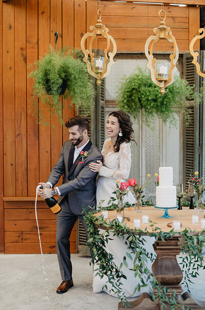 Argentine-Polo-Inspired-Wedding-at-Garrett-Field-Estancia-in-Louisiana-Couple-Popping-Champagne