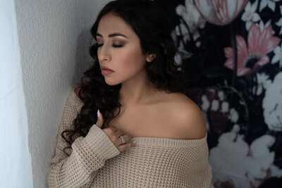 plus size woman posing with boudoir wings for portrait