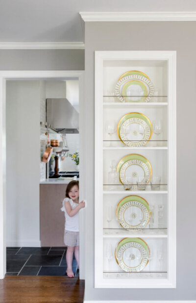 Dining room built-ins in Boston, Massachusetts, showcase custom cabinet design in a Westwood kitchen renovation, with new shelves creating a family-friendly interior.