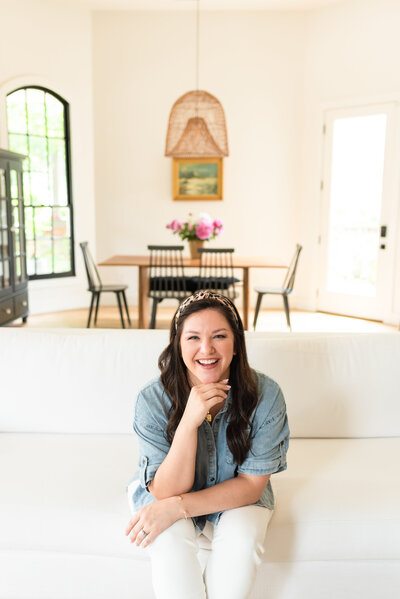 Madison Dearly sitting on a couch and smiling at the camera