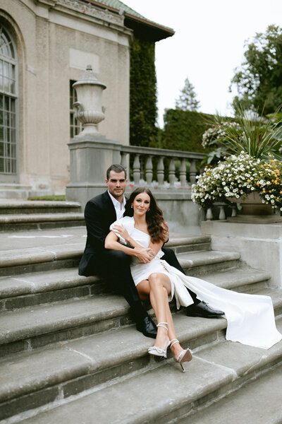 bride and groom sitting on steps of Montreal wedding venue