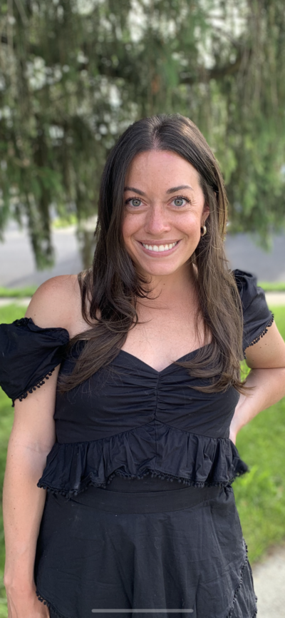 Emily Austin, anxiety and ocd therapist in new york, new jersey & florida, smiling in a casual black shirt—sharing who she is beyond the therapy room.