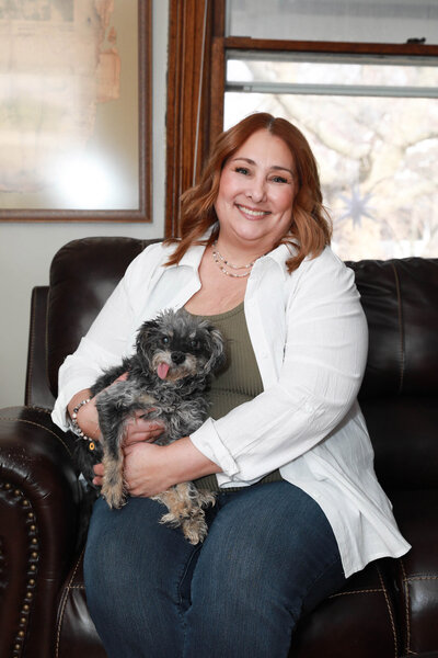 Kim holding her dog in her lap