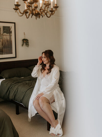 Bridal makeup artist Yana applying lipstick to client in her San Francisco beauty studio.