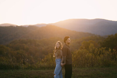 Engaged couple hiking through misty Smoky Mountain trails