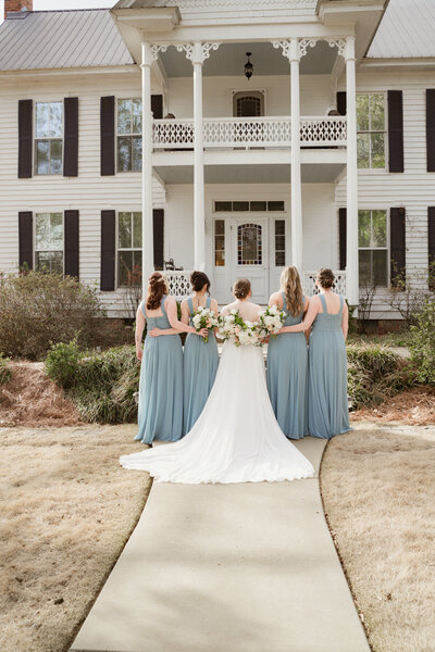 Bridal portrait with bridesmaids taken outside of venue