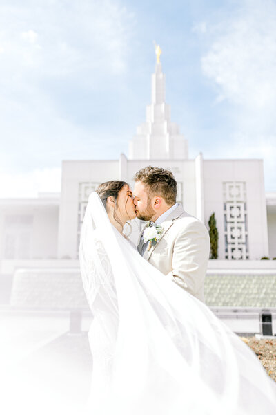 Couple at the Idaho Falls Temple Kissing with Veil