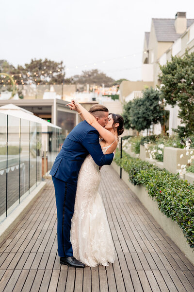 Groom twirling his bride at their wedding at Lauberge Del Mar