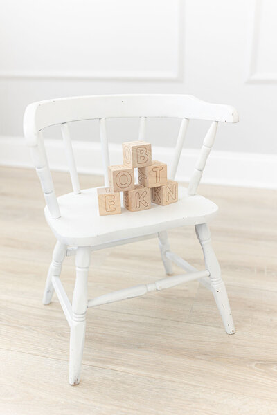 Kids white wooden chair with alphabet blocks
