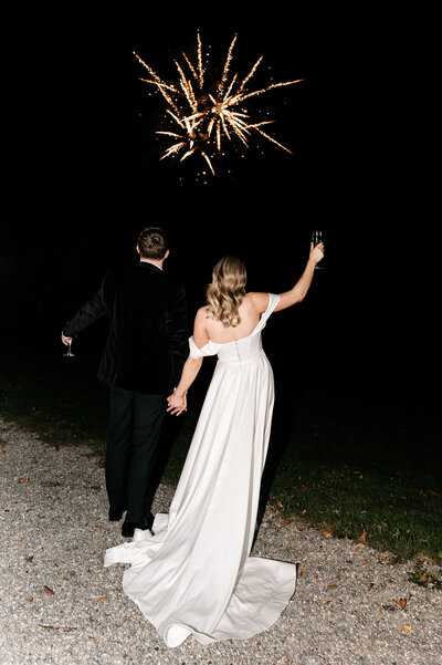 Bride and groom watching fireworks at their wedding in Ireland