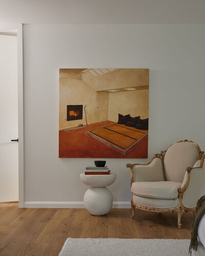 Contemporary art hung above a seating vignette