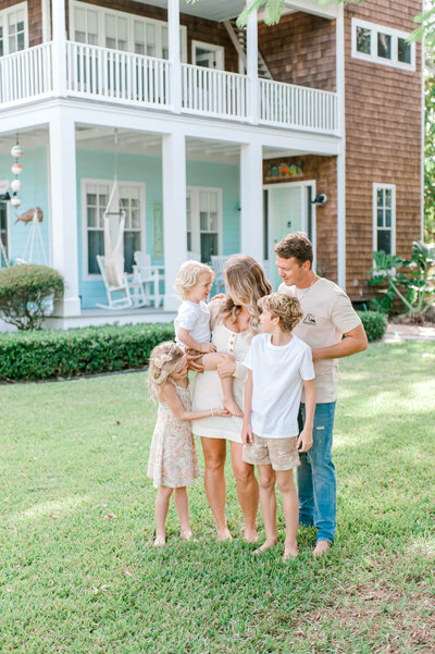 Blue marlin real estate owners family in front of their gorgeous estate in Merritt Island Florida enjoying an intimate moment with their family