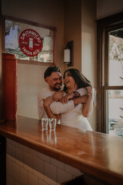 This couple started their engagement session at their favorite local bar and took a shot of tequila together..