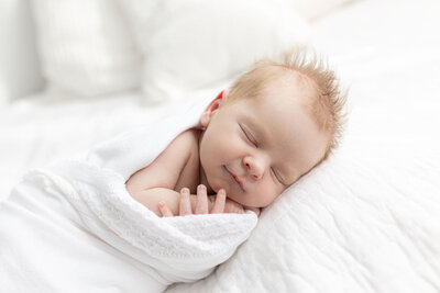 Newborn baby sleeping on beanbag in studio