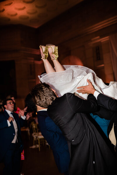 Bride crowd surfs on the dance floor of an East Coast destination wedding