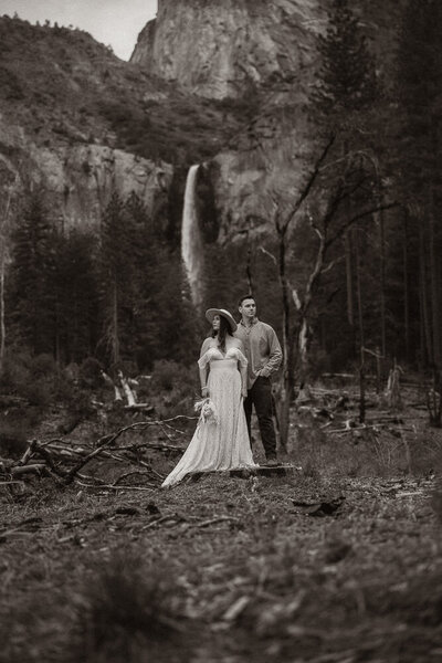 couple holding eachother in front of mountains