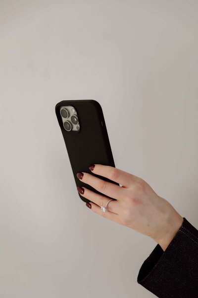 Natalie Jones holing her mobil phone in a black case