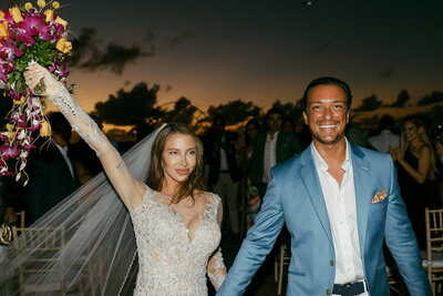 Bride and groom exiting their sunset ceremony at Cap Juluca in Anguilla