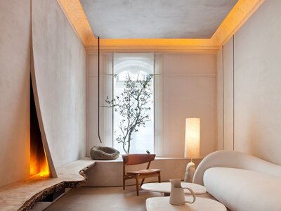 Living room with plaster walls, and organic shaped furniture in natural materials