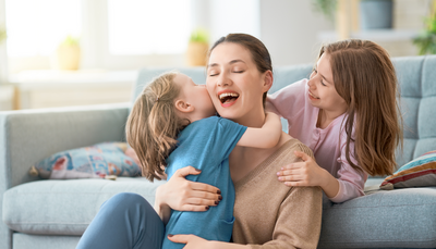 Edmonton mom and kids hugging while enjoying a biweekly cleaned home from Fresh Nest Green Cleaning