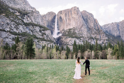 Bride and groom look at Yosemite falls during their Yosemite National Park elopement