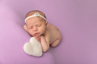 baby sleeping on purple with white heart by Newborn Photography Bucks County PA