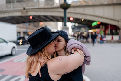 Couple hugging on sidewalk in New York.