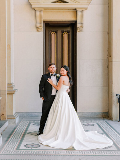 Bride and groom forehead to forehead on balcony at St Rocco Catholic Church wedding in Cleveland
