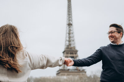 The MacMeekens in Paris holding hands in front of the Eiffel Tower