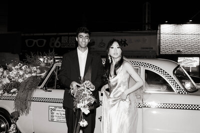 Fashion-forward couple walking through the streets of Brooklyn during a luxury destination elopement, photographed by a Denver-based wedding photographer. 