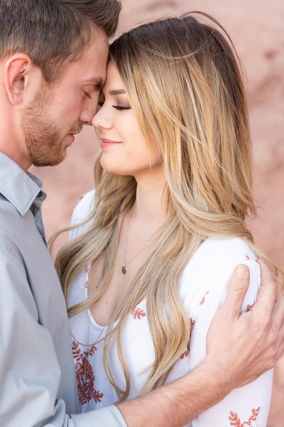 engaged couple with eyes closed